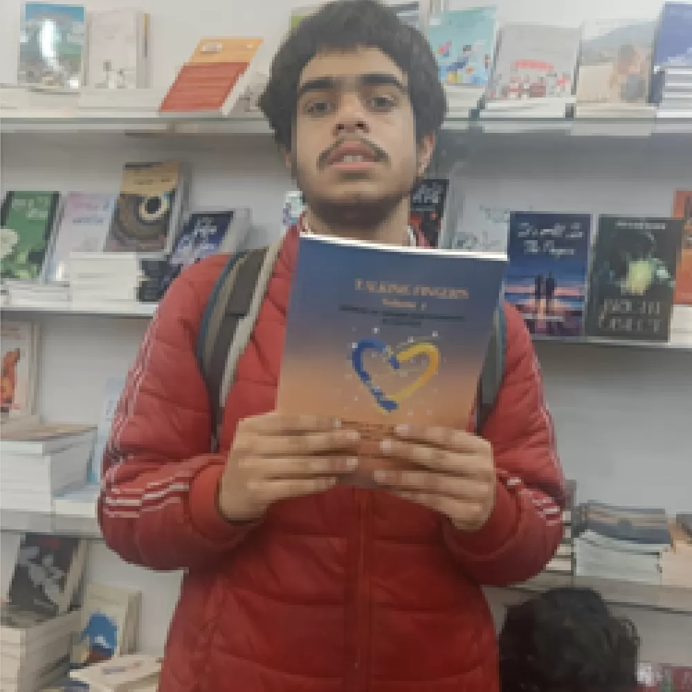 Saksham with his book "Talking Fingers" Where he has co-authored